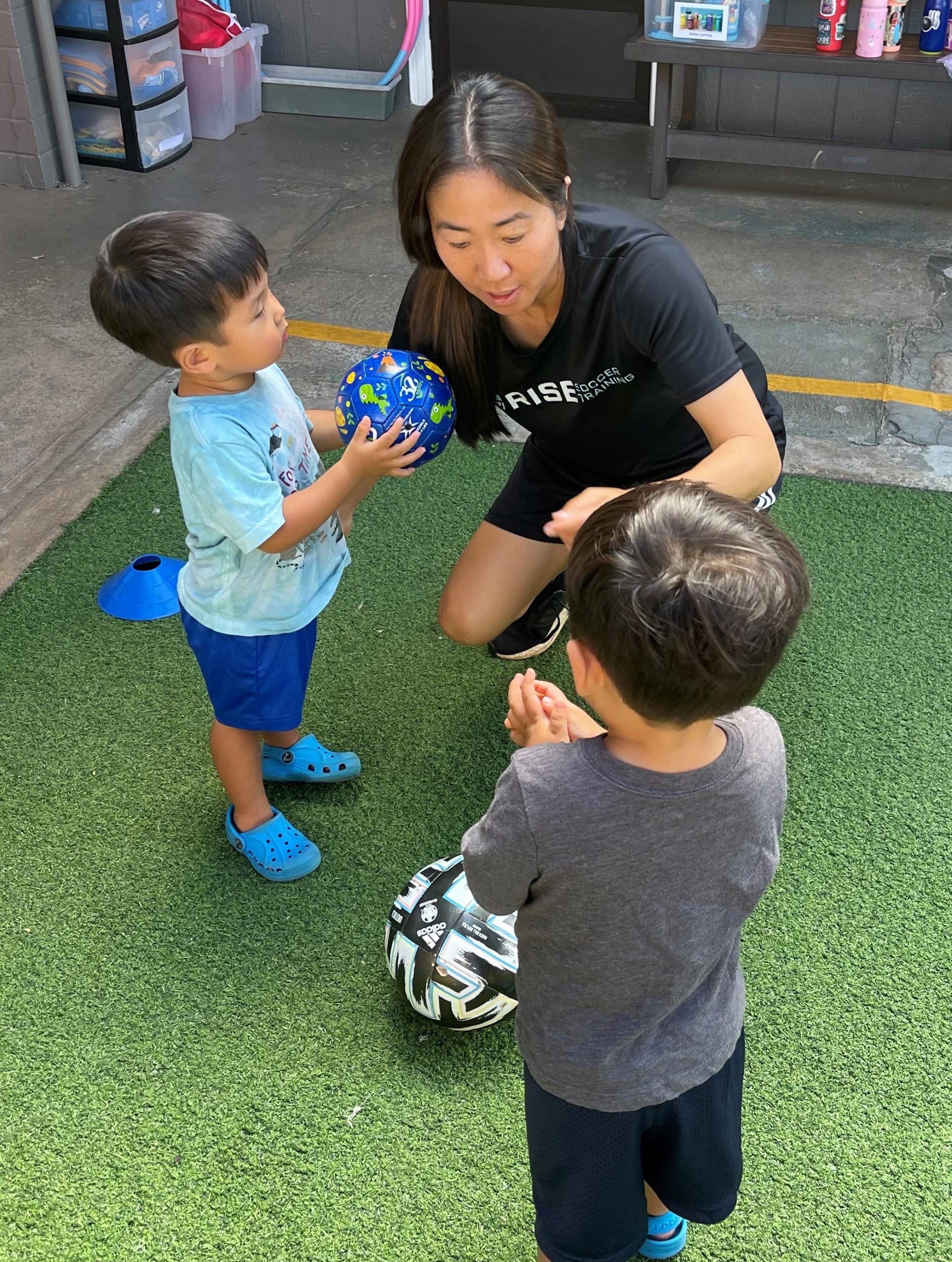 image of coach Erin with young soccer players
